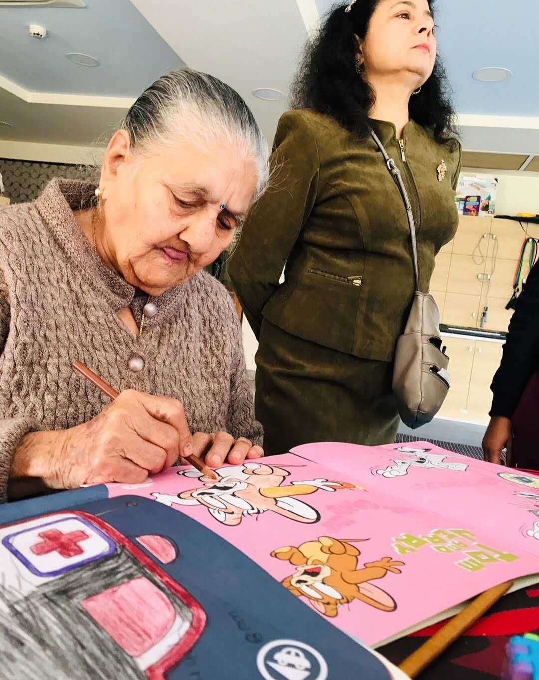 A resident enjoying a guided colouring activity