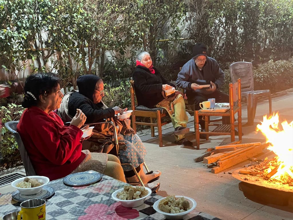 Residents gathered around an evening bonfire