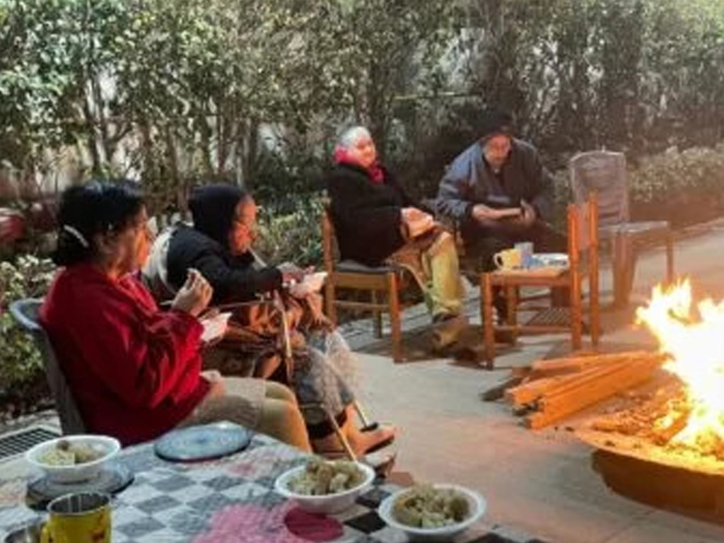 Residents enjoying an evening bonfire together