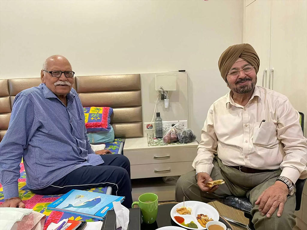 Two residents chatting in a resident room